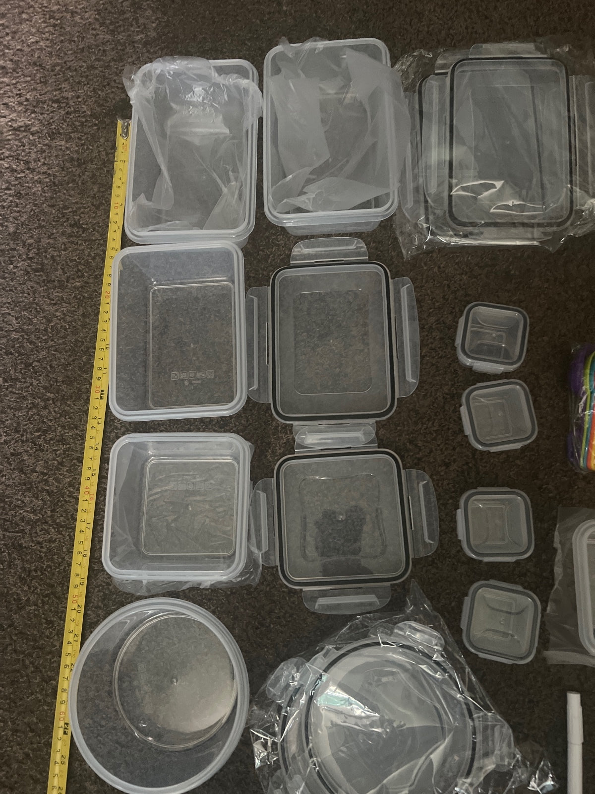 Set of Various Plastic Food Storage Containers with Labels and Measuring Spoons
