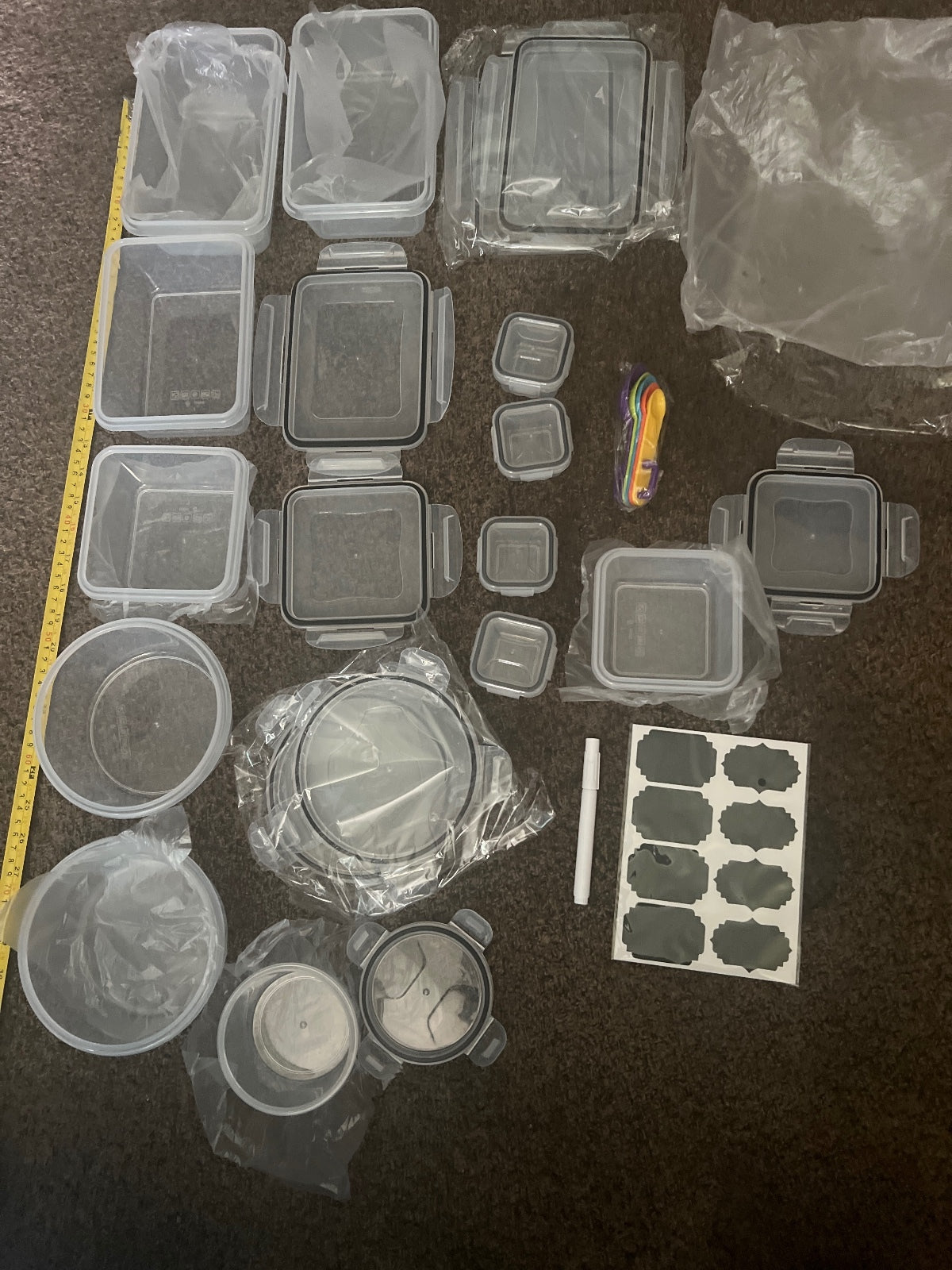 Set of Various Plastic Food Storage Containers with Labels and Measuring Spoons