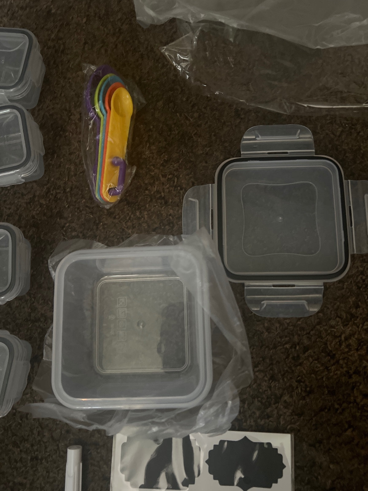 Set of Various Plastic Food Storage Containers with Labels and Measuring Spoons