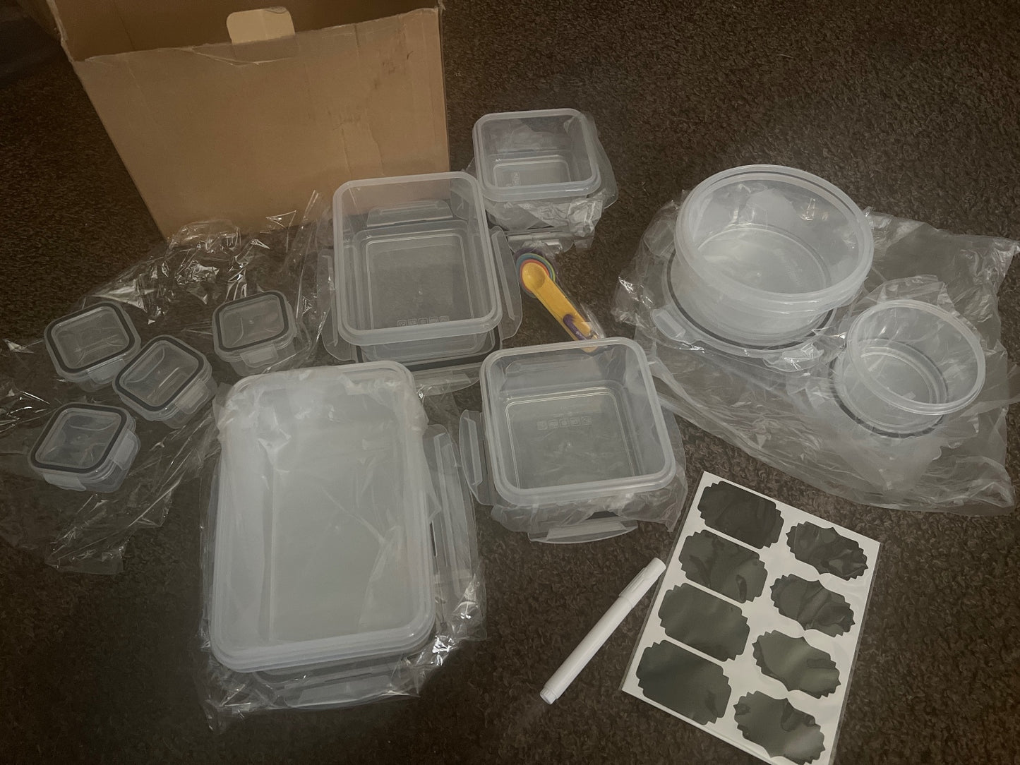 Set of Various Plastic Food Storage Containers with Labels and Measuring Spoons