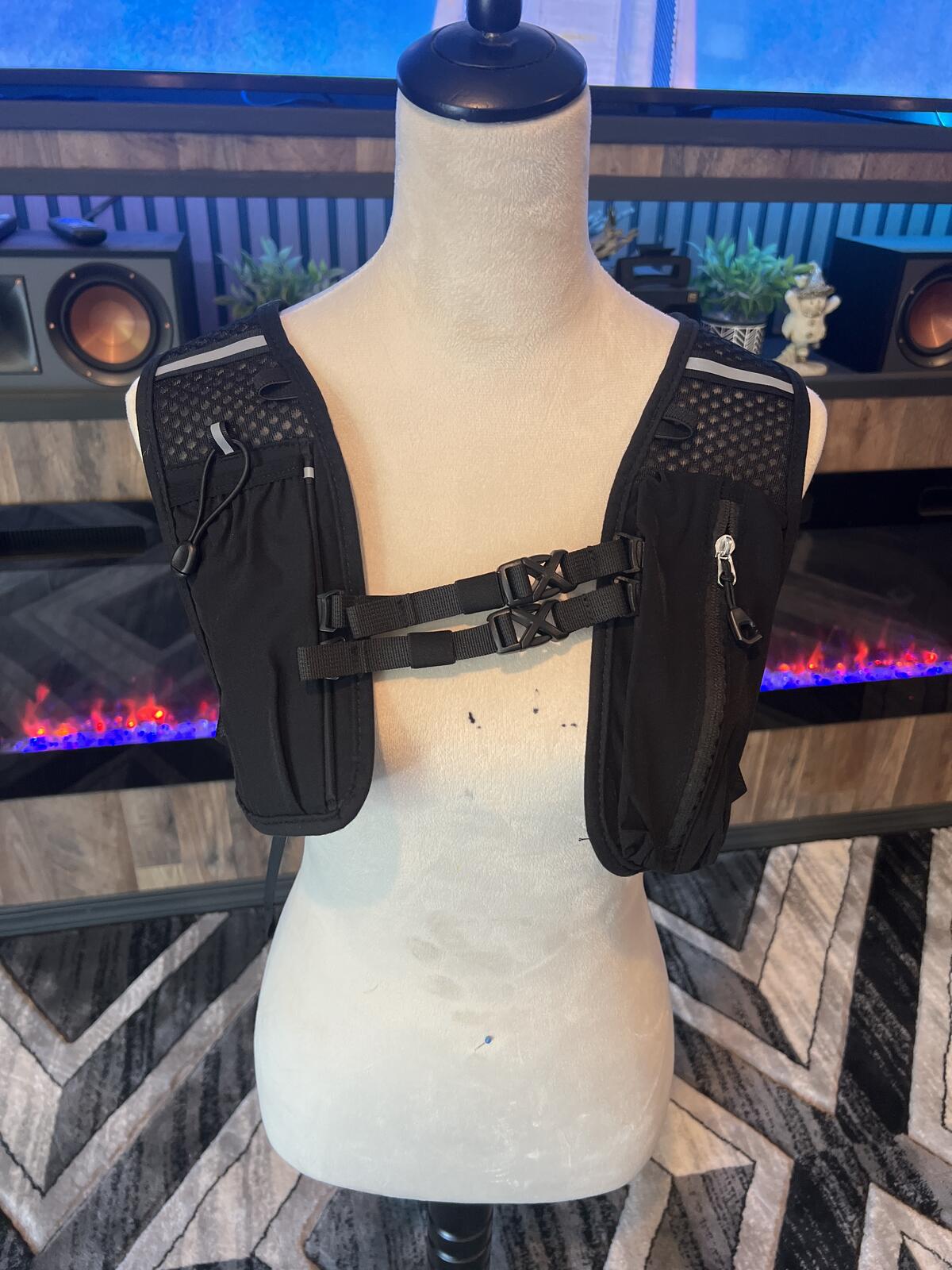 Black Hydration Vest Backpack with Adjustable Straps and Zipper Pockets